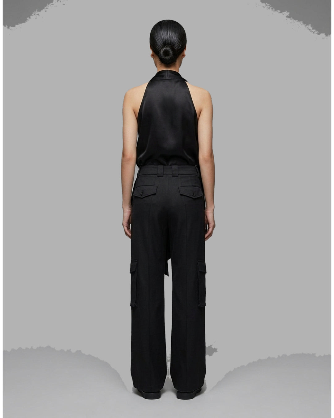 Black wide-leg cargo pants in crepe acetate mix with flap side pockets and panelled front, shown from the front - back
