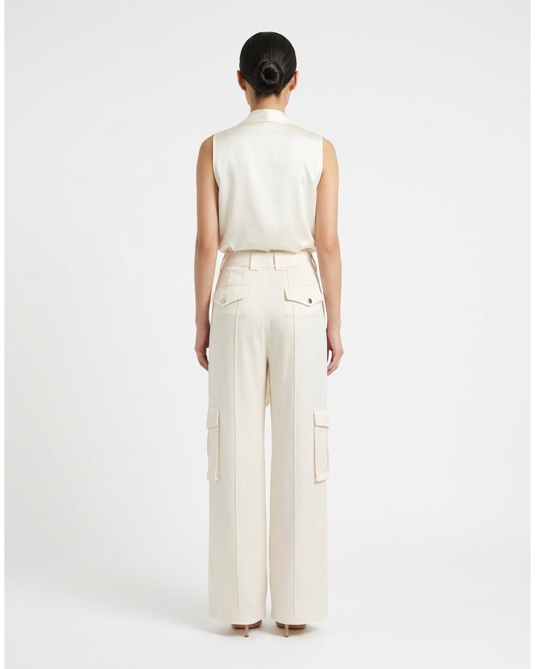 Cream wide-leg high-rise cargo pants in crepe acetate blend with flap pockets and pressed front crease - back