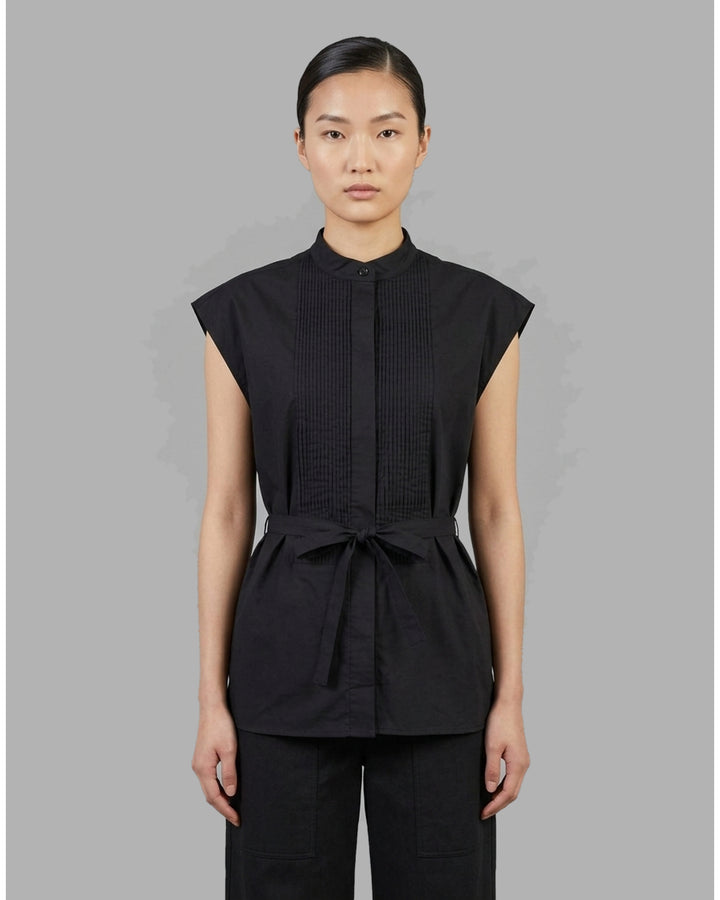 Black sleeveless cotton shirt with pintucked bib front, mandarin collar and self-fabric waist tie - front