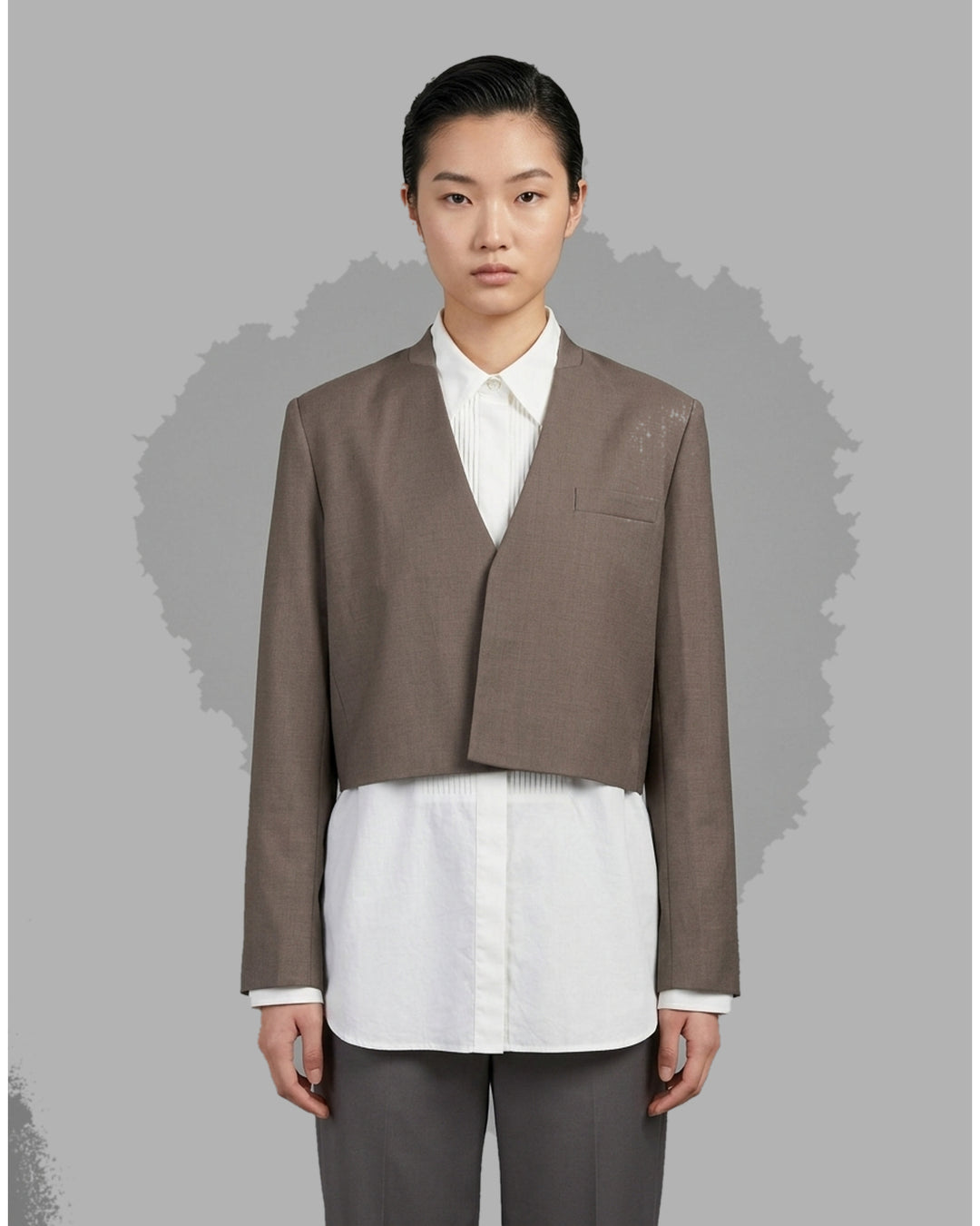 Black collarless cropped jacket with asymmetric wrap front and chest flap detail by Club21 Collection - front