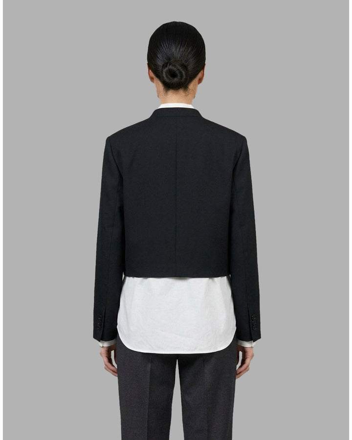 Black collarless cropped jacket with asymmetric wrap front and chest flap detail by Club21 Collection - back