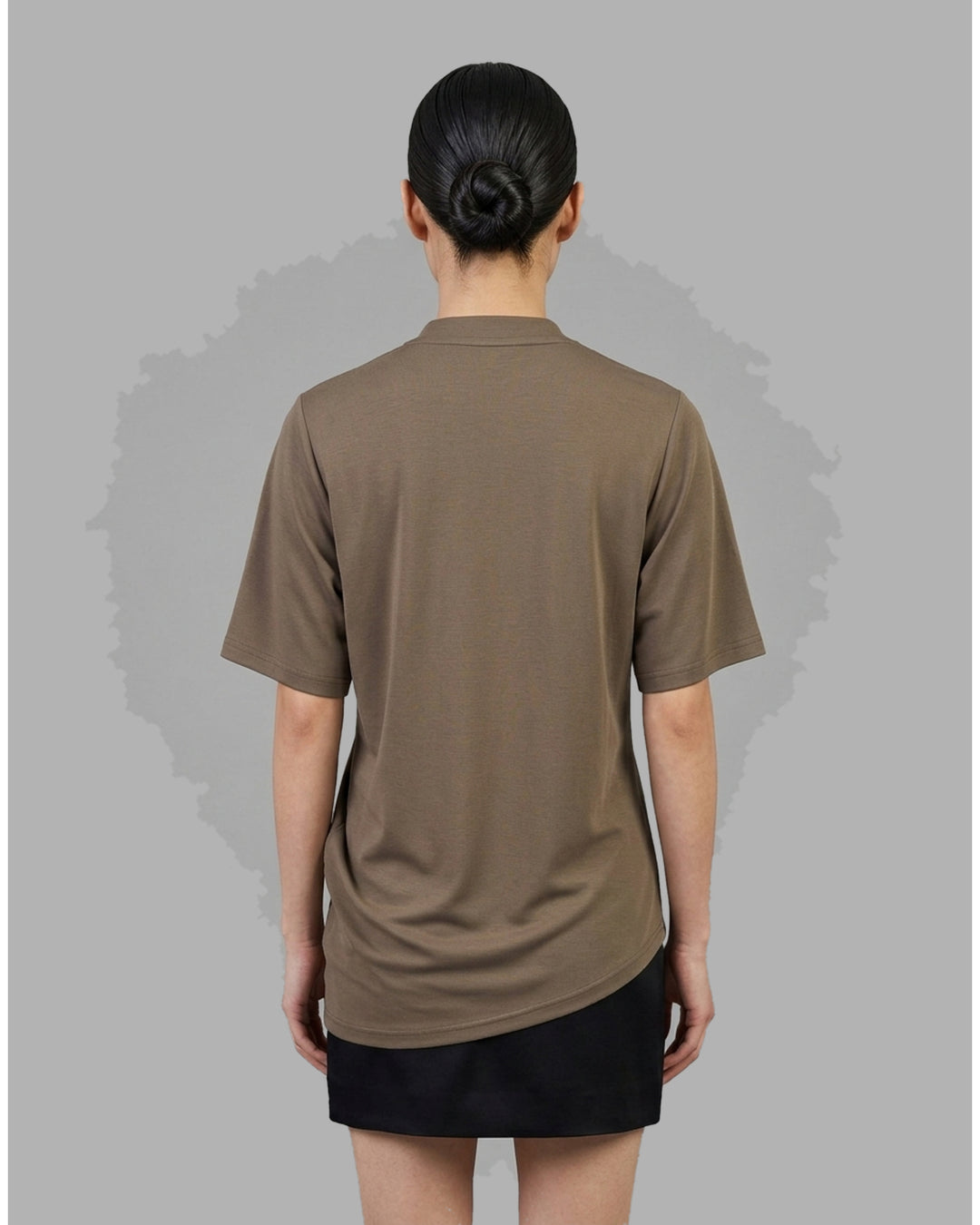 Taupe brown mock-neck short sleeve jersey tee with gathered draping at the side seam and an asymmetric hem - back