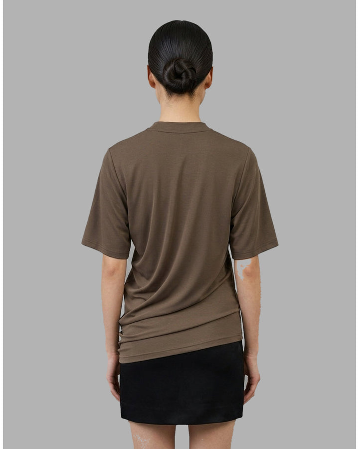 Black short-sleeve crew neck jersey tee with gathered side draping and an asymmetric hem, shown flat against a white background - back