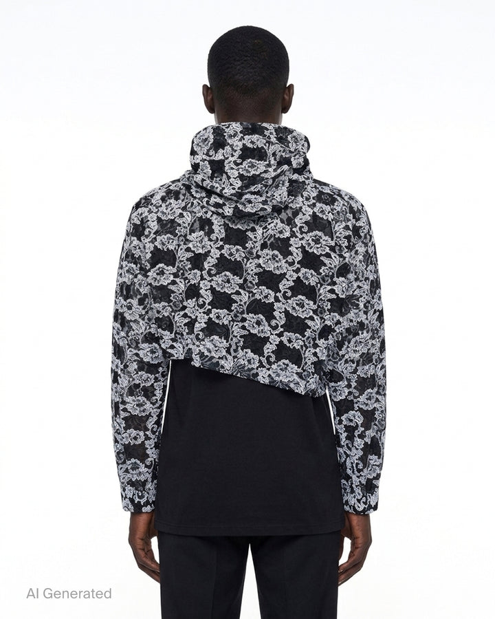 Comme des Garçons Homme Plus cropped hooded jacket in black and white floral embroidered nylon tulle with asymmetric raw hem and drawstring hood - back