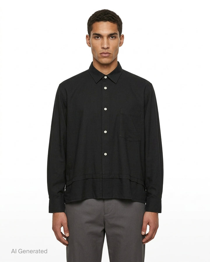 Comme des Garçons Homme Plus black polyester broad long sleeve shirt with layered hem, chest pocket, and mother-of-pearl button fastening, front view - front