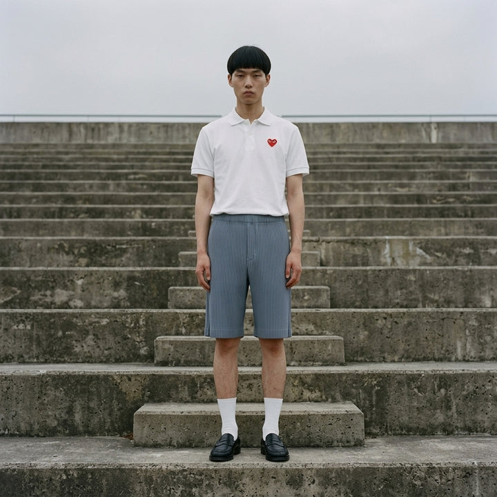 White short sleeve polo tee with embroidered red heart logo on the chest by Comme des Garçons Play - lifestyle