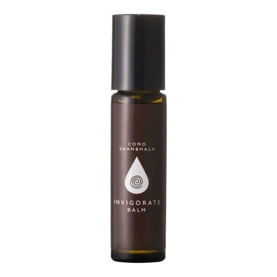 COMO Shambhala Invigorate Balm roll-on in an amber glass bottle with a black cap and white droplet emblem label - packshot