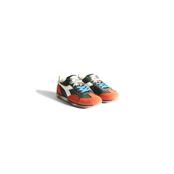 Diadora x JW Anderson retro nylon sneaker in blue with khaki suede overlays, coral laces, and a white Diadora logo stripe, set against a white background - packshot