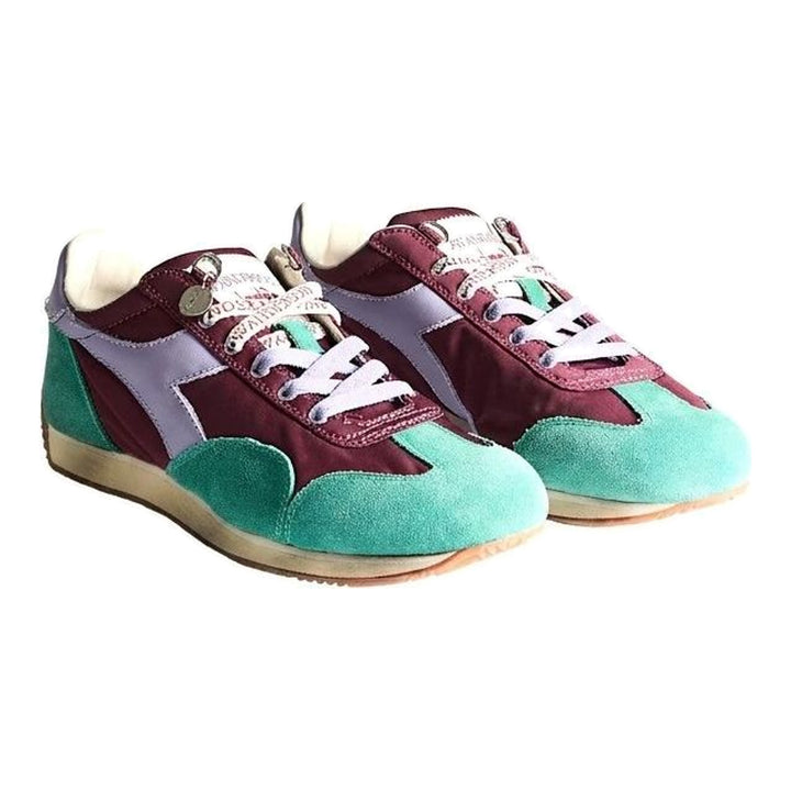 Diadora x JW Anderson retro nylon sneaker in blue with khaki suede overlays, coral laces, and a white Diadora logo stripe, set against a white background - packshot