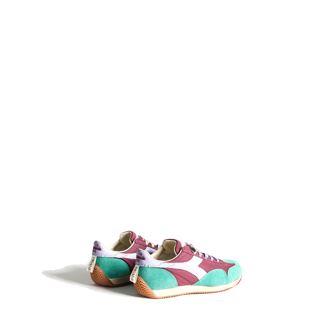 Diadora x JW Anderson retro nylon sneaker in blue with khaki suede overlays, coral laces, and a white Diadora logo stripe, set against a white background - packshot