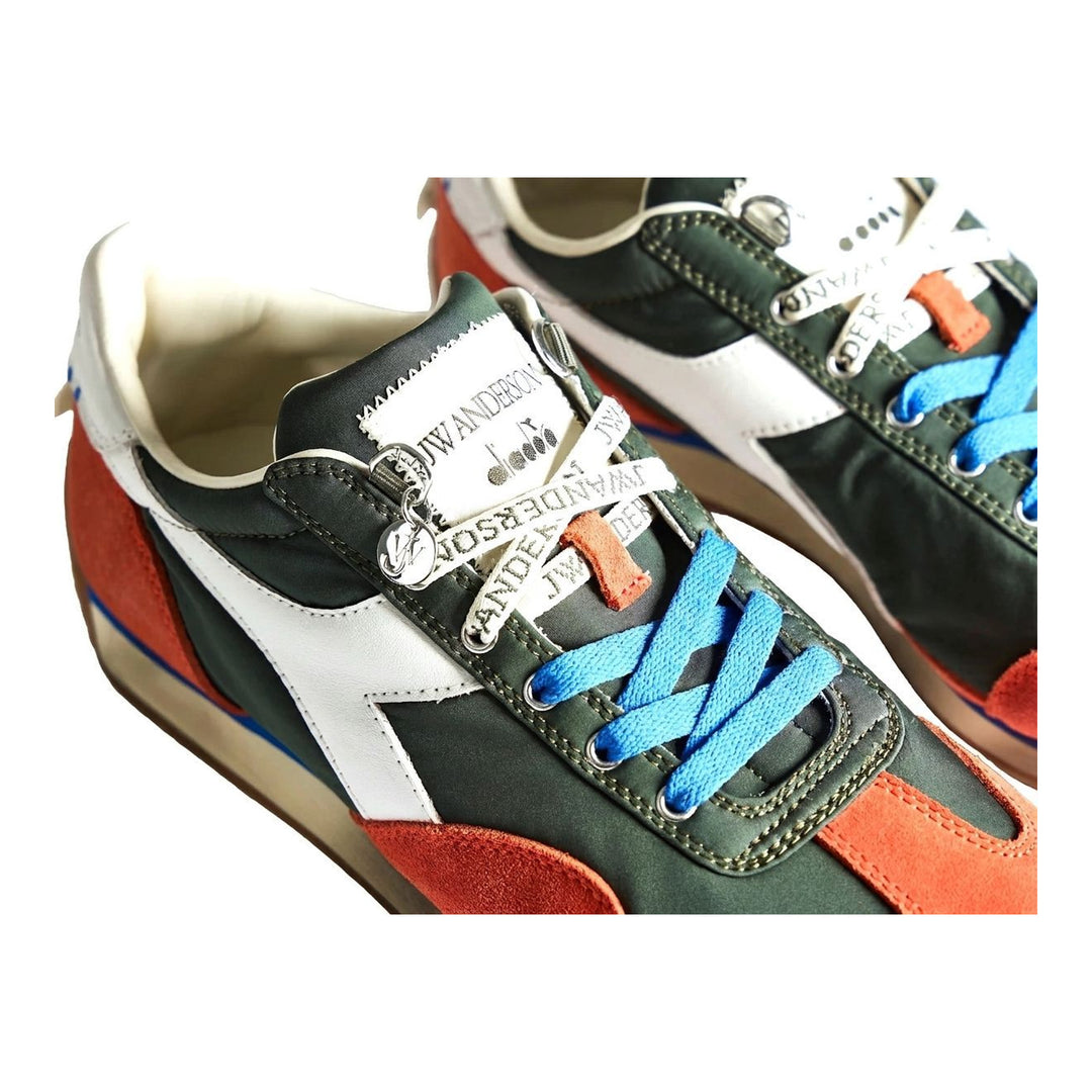 Diadora x JW Anderson retro nylon sneaker in blue with khaki suede overlays, coral laces, and a white Diadora logo stripe, set against a white background - packshot