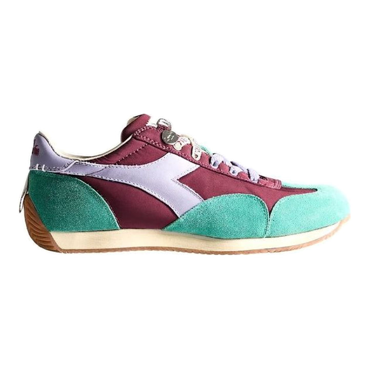 Diadora x JW Anderson retro nylon sneaker in blue with khaki suede overlays, coral laces, and a white Diadora logo stripe, set against a white background - packshot
