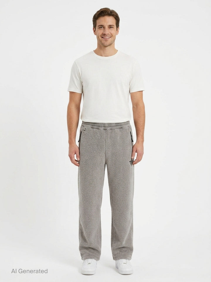 doublet Air Yarn Fleece Pants in heather grey, shown flat — wide-leg silhouette with speckled fleece texture, zip side pockets, elasticated drawstring waistband, and embroidered triangle logo patch at the hip - front