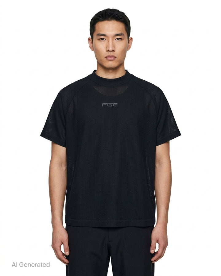 Fear of God Essentials Essential Raglan Tee in black with tonal FGE logo on the chest and ribbed crewneck, shown flat from the front - front