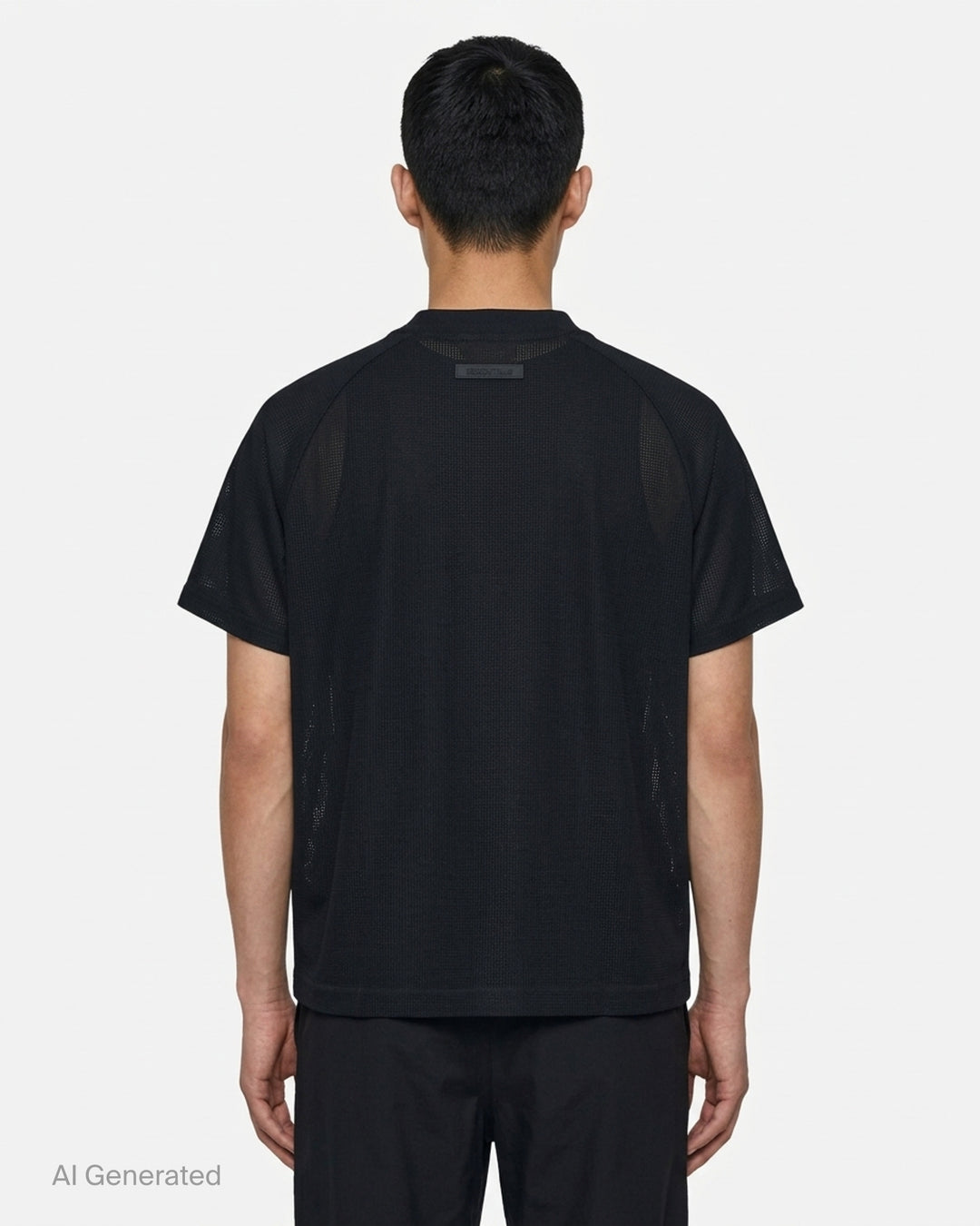 Fear of God Essentials Essential Raglan Tee in black with tonal FGE logo on the chest and ribbed crewneck, shown flat from the front - back