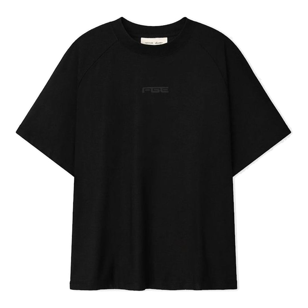 Fear of God Essentials Essential Raglan Tee in black with tonal FGE logo on the chest and ribbed crewneck, shown flat from the front - packshot