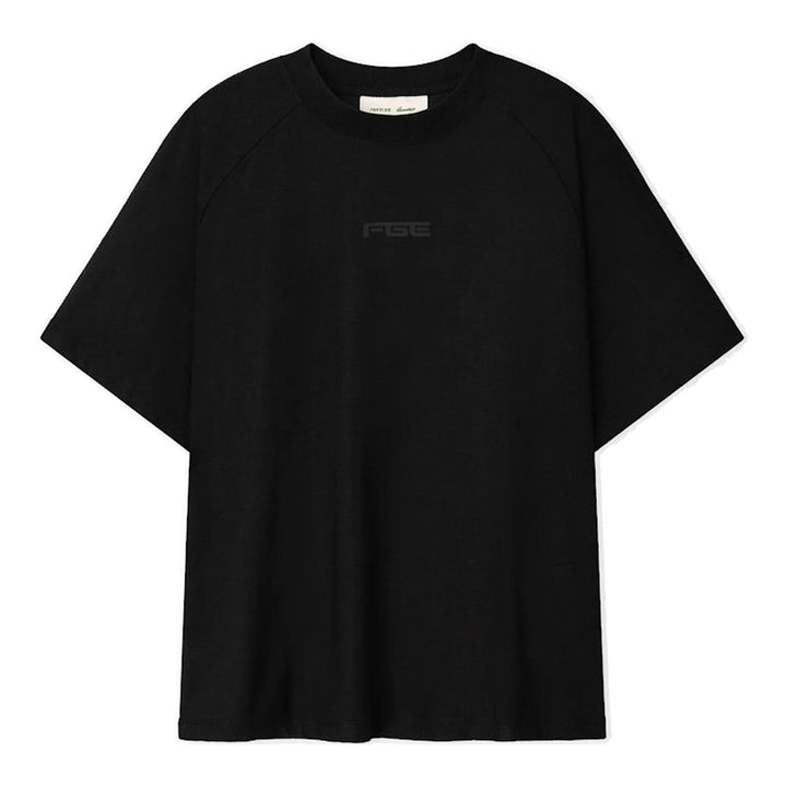 Fear of God Essentials Essential Raglan Tee in black with tonal FGE logo on the chest and ribbed crewneck, shown flat from the front - packshot