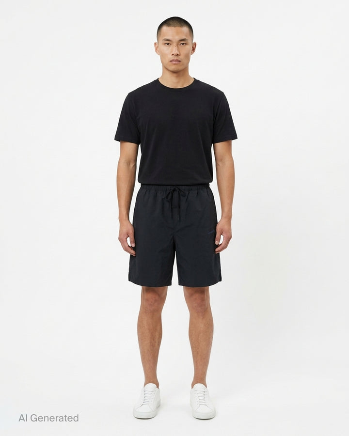 Fear of God Essentials Signature Relaxed Shorts in black, featuring an elasticated drawstring waistband, wide-leg silhouette, and tonal script logo embroidery on the front panel - front