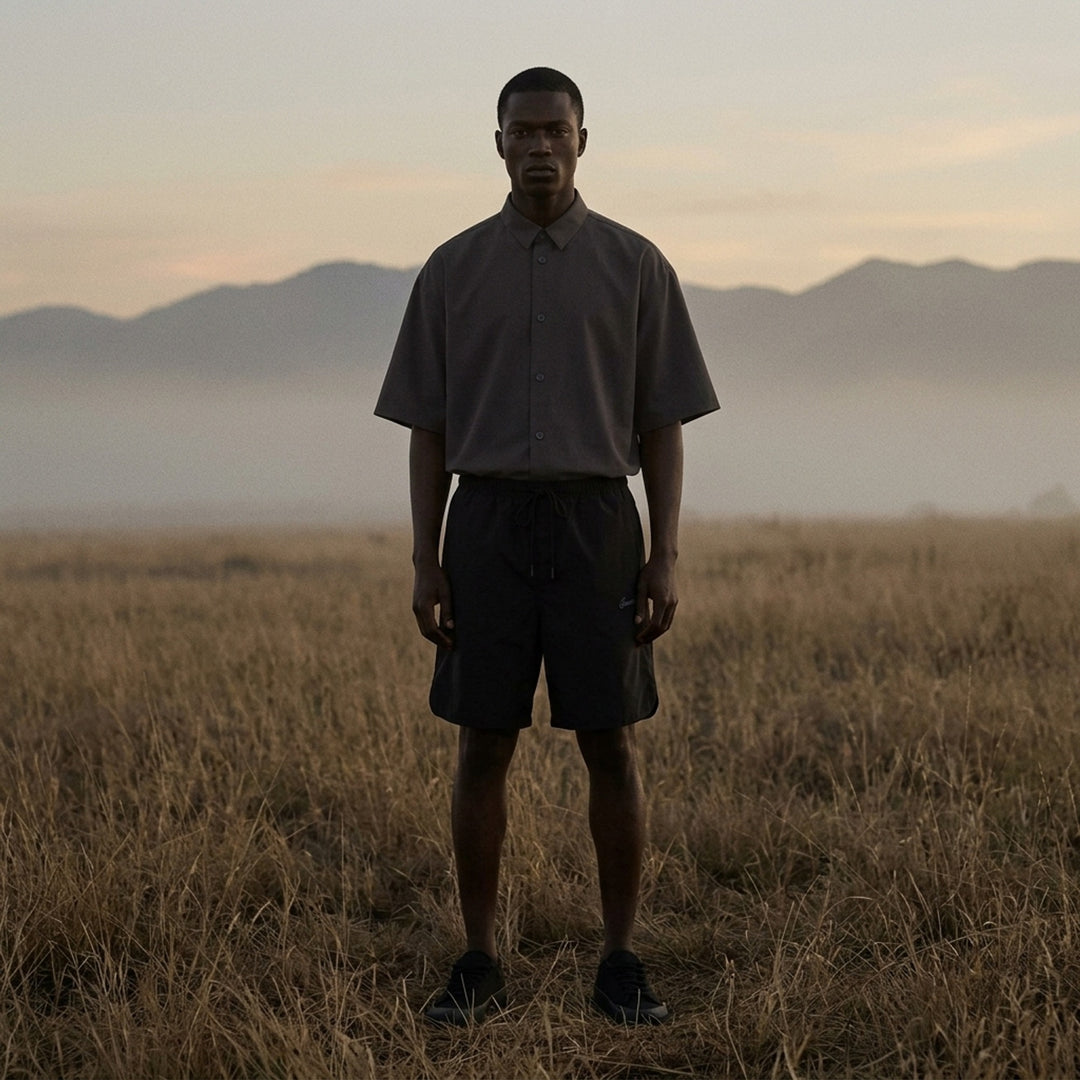 Fear of God Essentials Signature Relaxed Shorts in black, featuring an elasticated drawstring waistband, wide-leg silhouette, and tonal script logo embroidery on the front panel - lifestyle