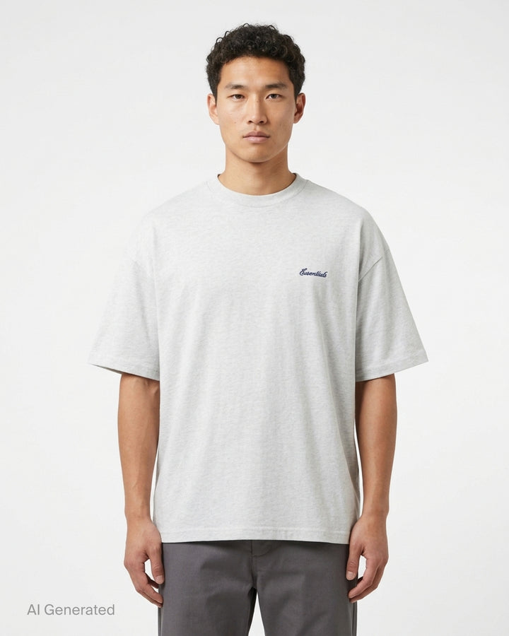Fear of God Essentials Signature Short Sleeve Tee in washed grey, featuring an oversized boxy silhouette, ribbed crewneck, and tonal script logo at the chest - front