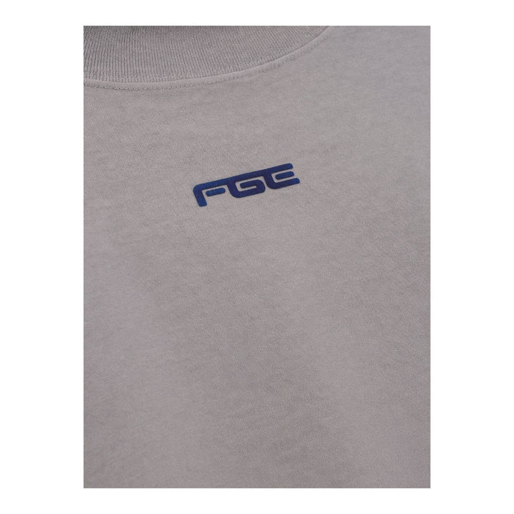 Fear of God ESSENTIALS women's slim mockneck tee in black with ribbed high neck, short sleeves and small white logo at the centre chest - packshot