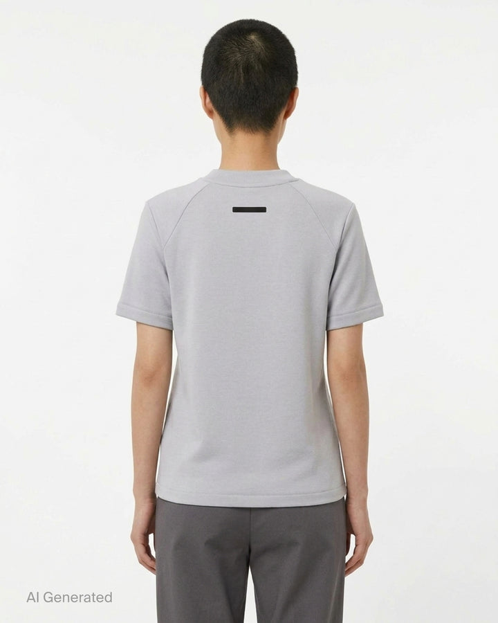 Fear of God Essentials women's tight tee in heathered taupe-grey with mock neckline and short sleeves, shown flat against a white background - back