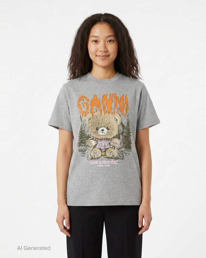 Ganni relaxed graphic cotton tee in heathered grey with orange flame-style Ganni logo, illustrated teddy bear holding a Ganni sign, pine forest motif, and 'Have a nice day! Please recycle' text on the front - front