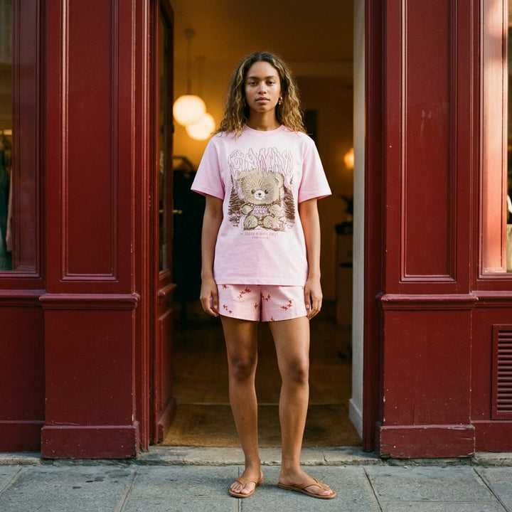 Ganni pink relaxed cotton t-shirt with gothic logo lettering and fluffy teddy bear woodland graphic print and 'Have a nice day! Please recycle' slogan - lifestyle