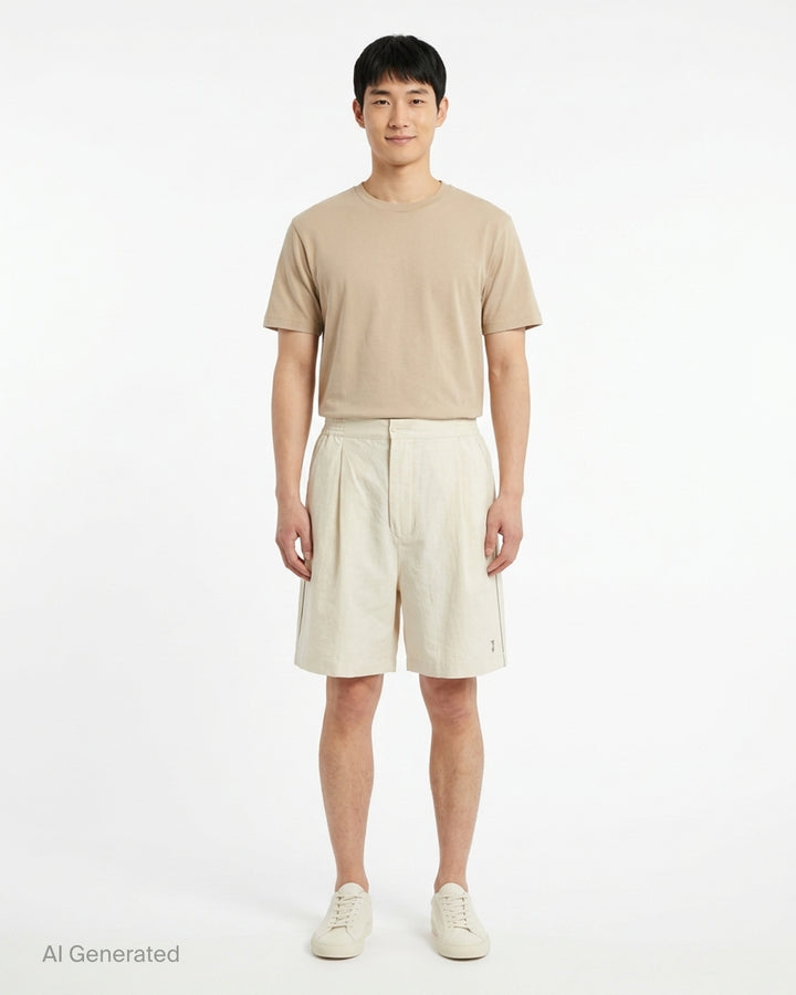 Jacquemus Le Short Pyjama cream pleated shorts with elasticated waistband, button closure and side piping, shown from the front - front