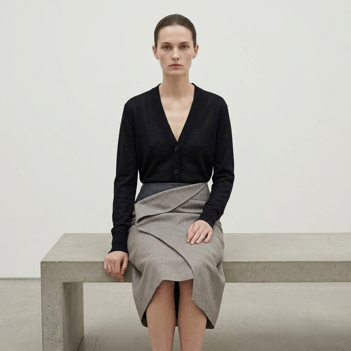 Jil Sander Subtle Check Wrap Skirt in taupe melange wool with sculptural origami fold at waist and diagonal overlay seam, midi length, side view - lifestyle