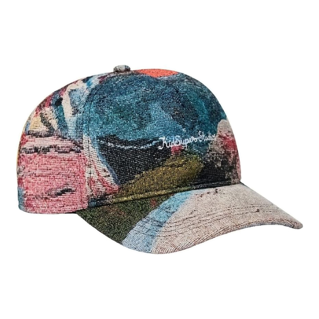 KidSuper Studios jacquard art cap in a multicolour painterly woven pattern with white embroidered script logo, front view - packshot