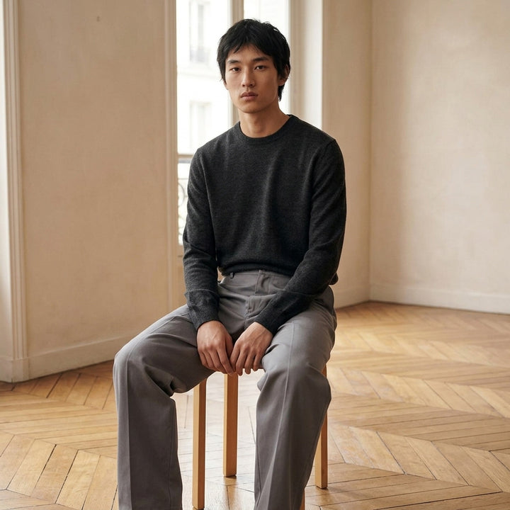 Lemaire crew neck sweater in dark charcoal mouliné knit with ribbed neckline, cuffs, and hem on a white background - lifestyle