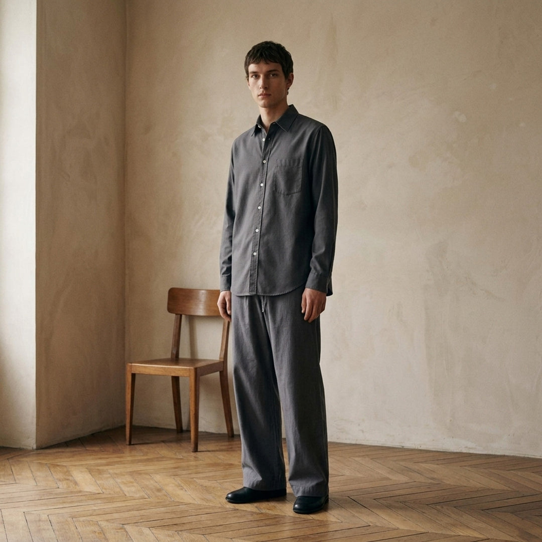Lemaire Regular Long Sleeve Washed Cotton Shirt in slate grey, displayed flat against a white background, featuring a classic collar, white buttons, and a chest patch pocket - lifestyle