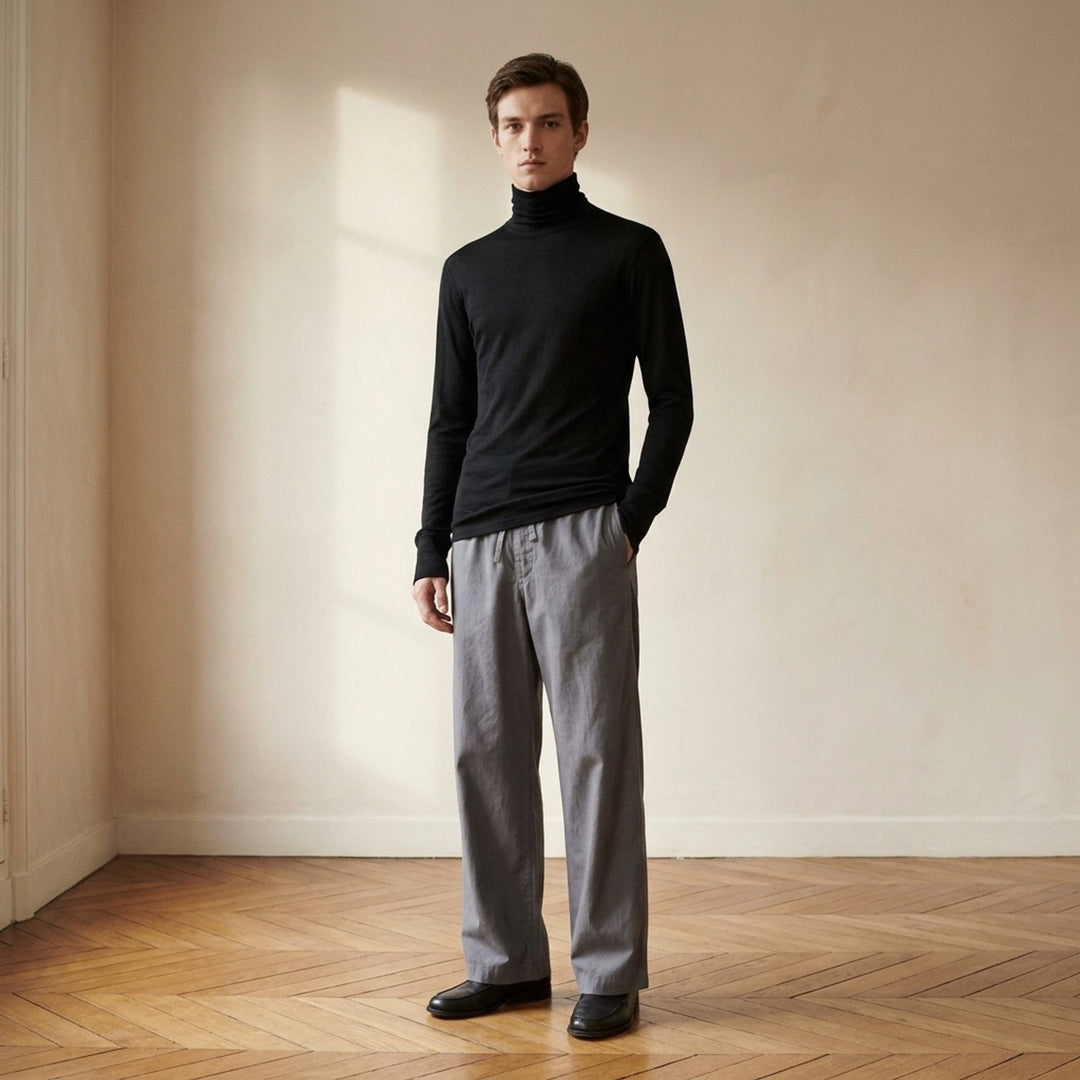 Lemaire black wool silk jersey turtleneck top with long sleeves and ribbed cuffs, shown front view - lifestyle