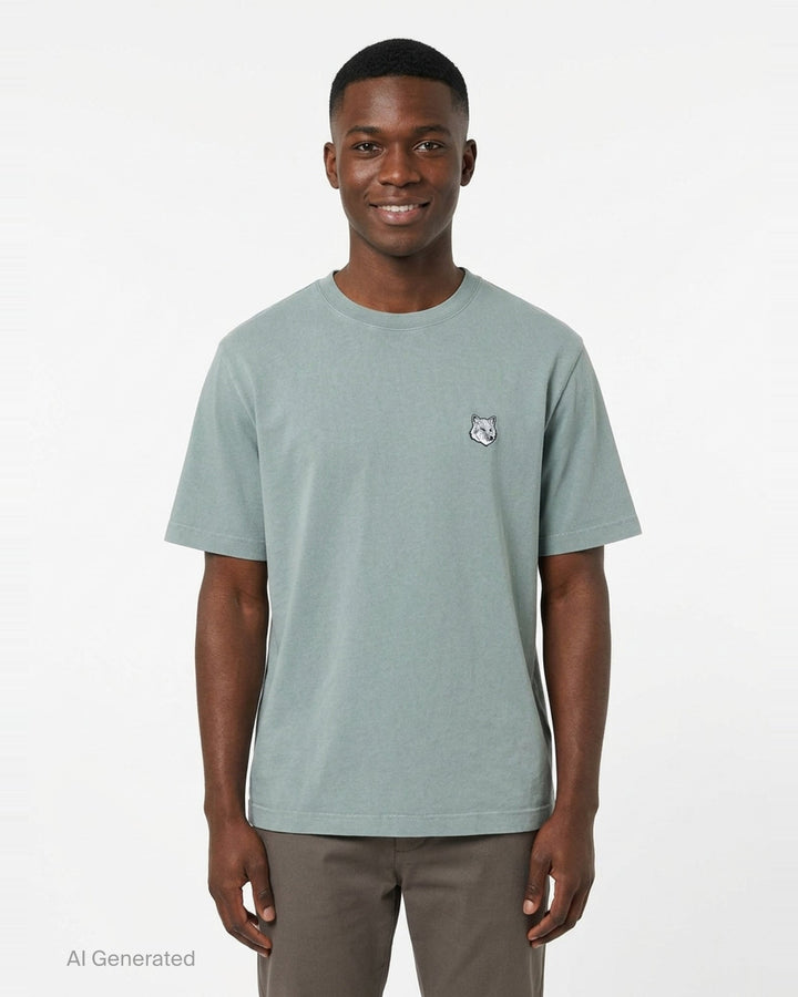 Maison Kitsuné Fox Head Faded Oversize Tee in washed sage green with embroidered fox head motif on the chest - front