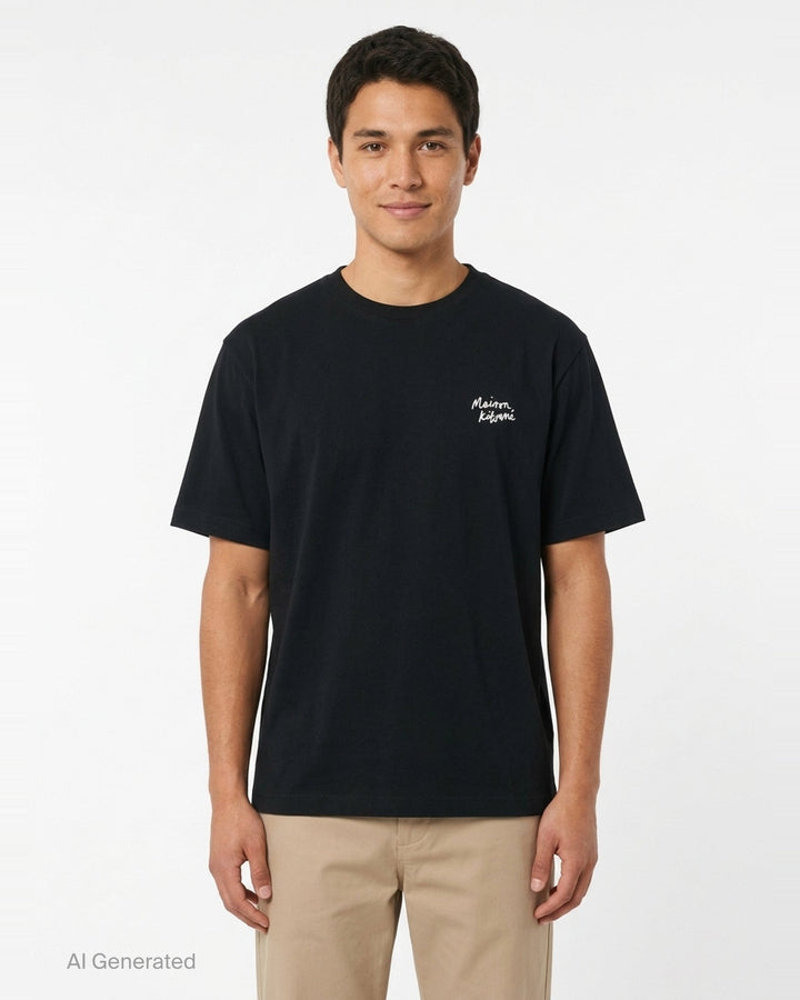 Maison Kitsuné Handwriting Oversized Tee in black with embroidered white script logo on the chest, front view - front