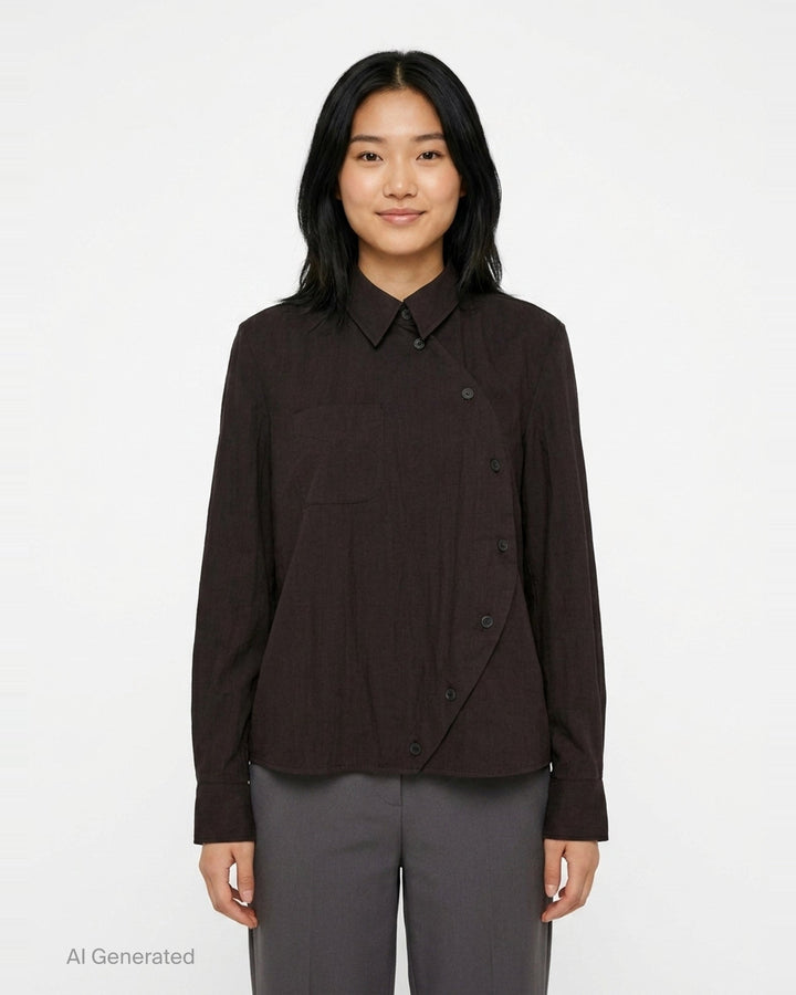 Melitta Baumeister Circle Shirt in black, featuring an asymmetric curved button placket, point collar, chest patch pocket, and structured long sleeves with wide cuffs - front