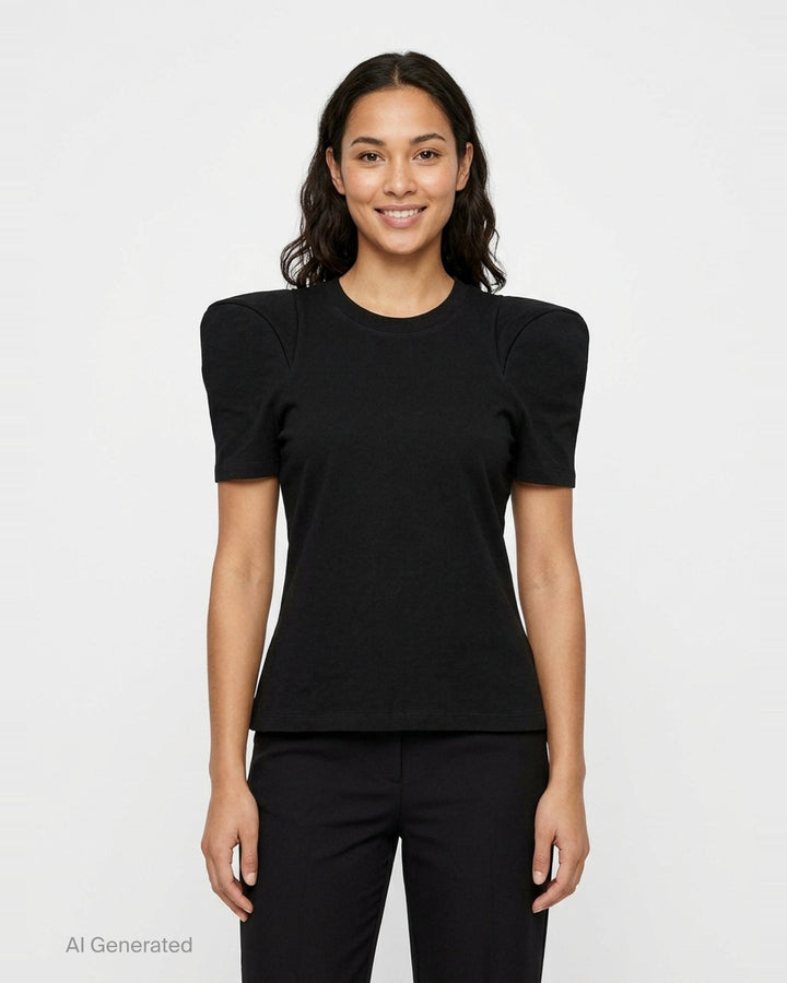 Melitta Baumeister Foamy Shoulder Tee in black, featuring exaggerated sculptural puff shoulders, ribbed crew neckline, and a fitted short-sleeve silhouette, shown on a flat lay against a white background - front
