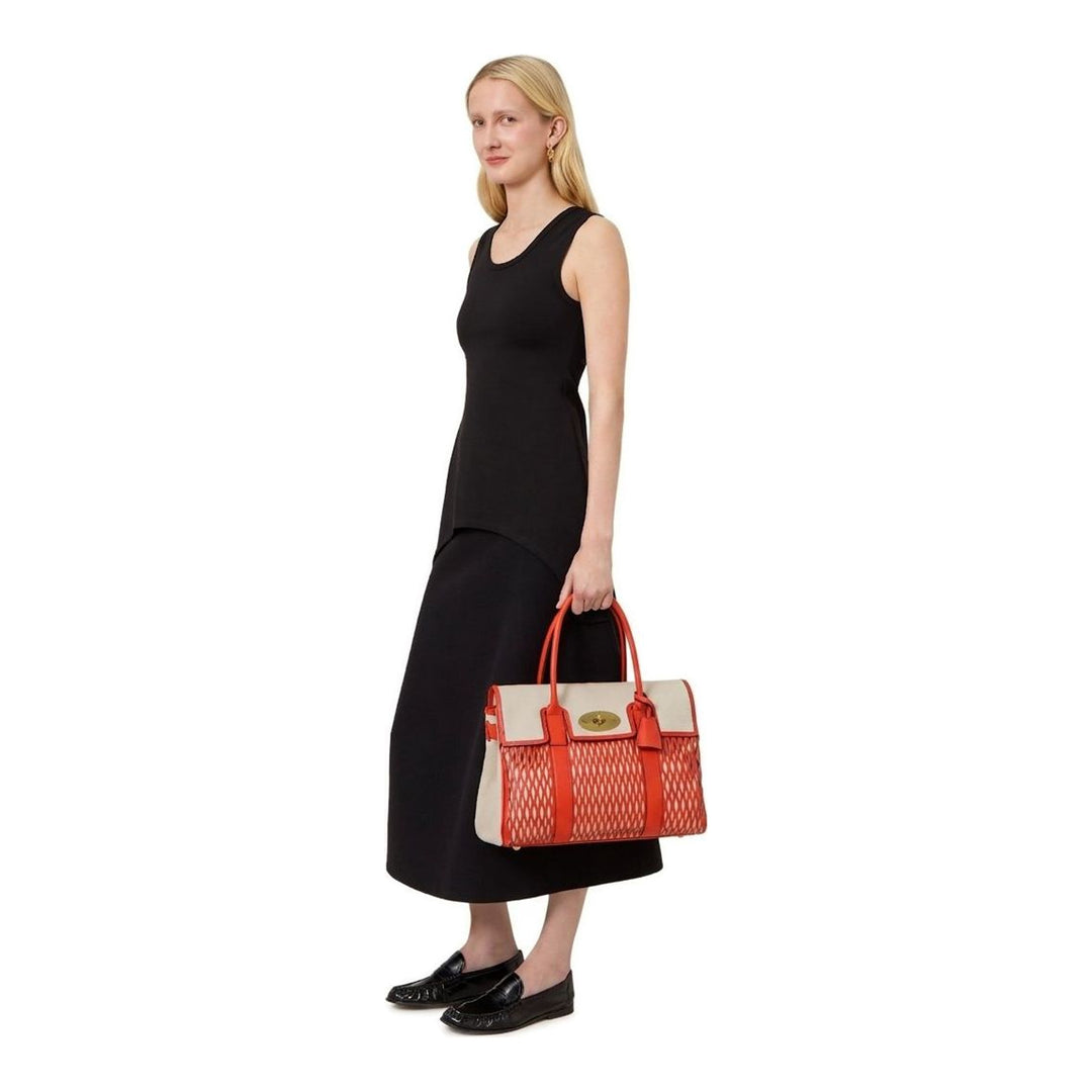 Mulberry Bayswater structured top-handle bag in coral leather and natural canvas with geometric cut-out detailing and gold postman's lock closure - packshot