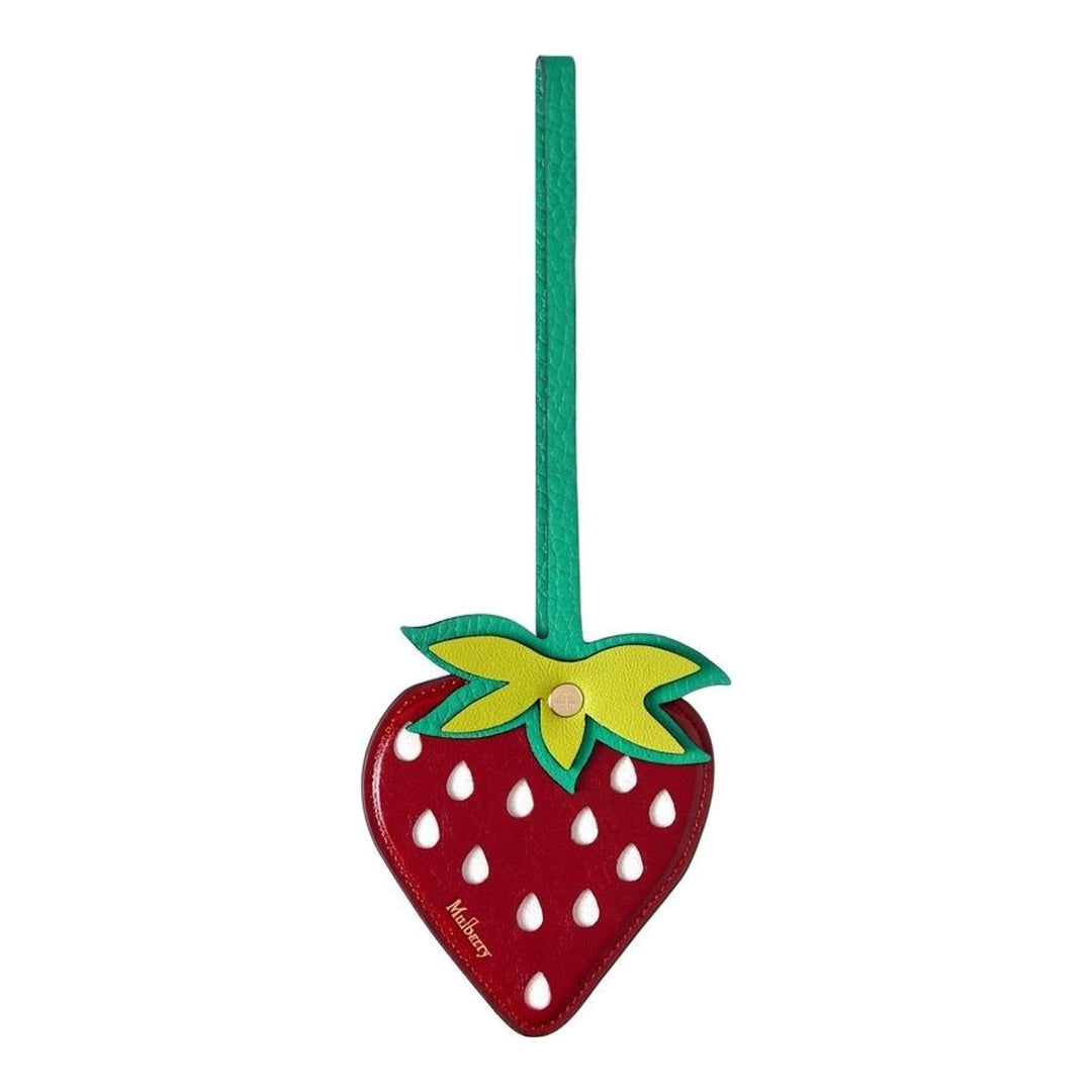 Mulberry Strawberry Bag Charm in red leather with white seed details, layered green calyx, gold stud hardware, and teal leather loop strap, photographed against a white background - packshot