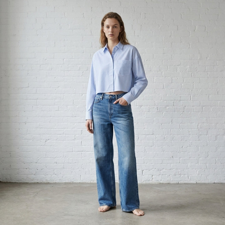 rag & bone Logan Wide Jeans in a faded mid-blue wash, shown from the front with a high-rise waist and wide straight leg - lifestyle