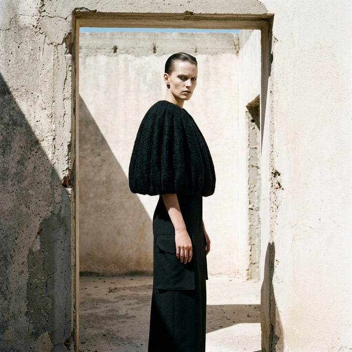 Rick Owens Temple Bubble Cropped Cape in black brushed mohair-blend, rear view showing sculptural quilted channelling and cocoon silhouette - lifestyle