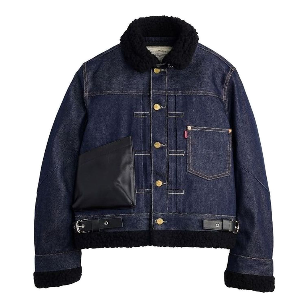 sacai x Levi's women's indigo denim trucker jacket with cream sherpa collar, cuffs and hem, leather patch pocket and buckled side straps - packshot
