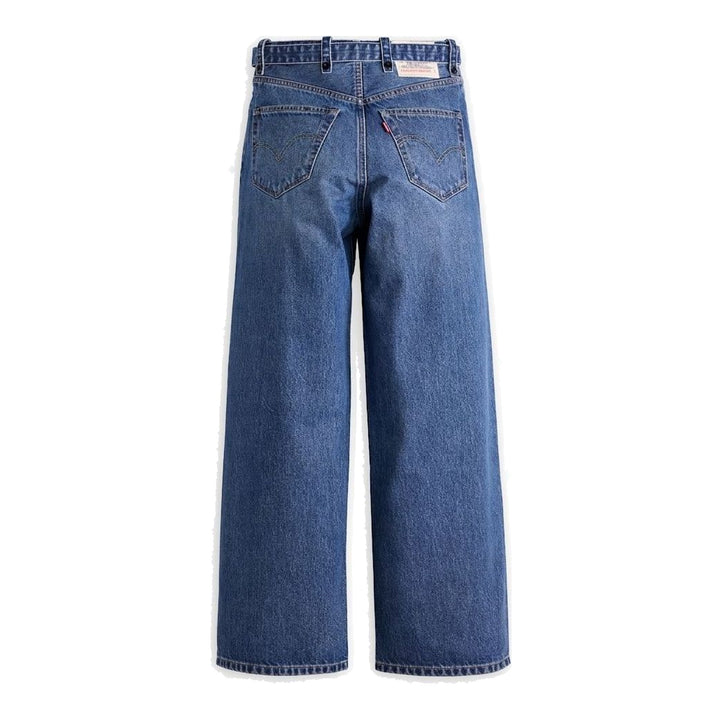 sacai x Levi's wide-leg mid-wash blue jeans with layered waistband and integrated webbing belt, shown flat from the front - packshot