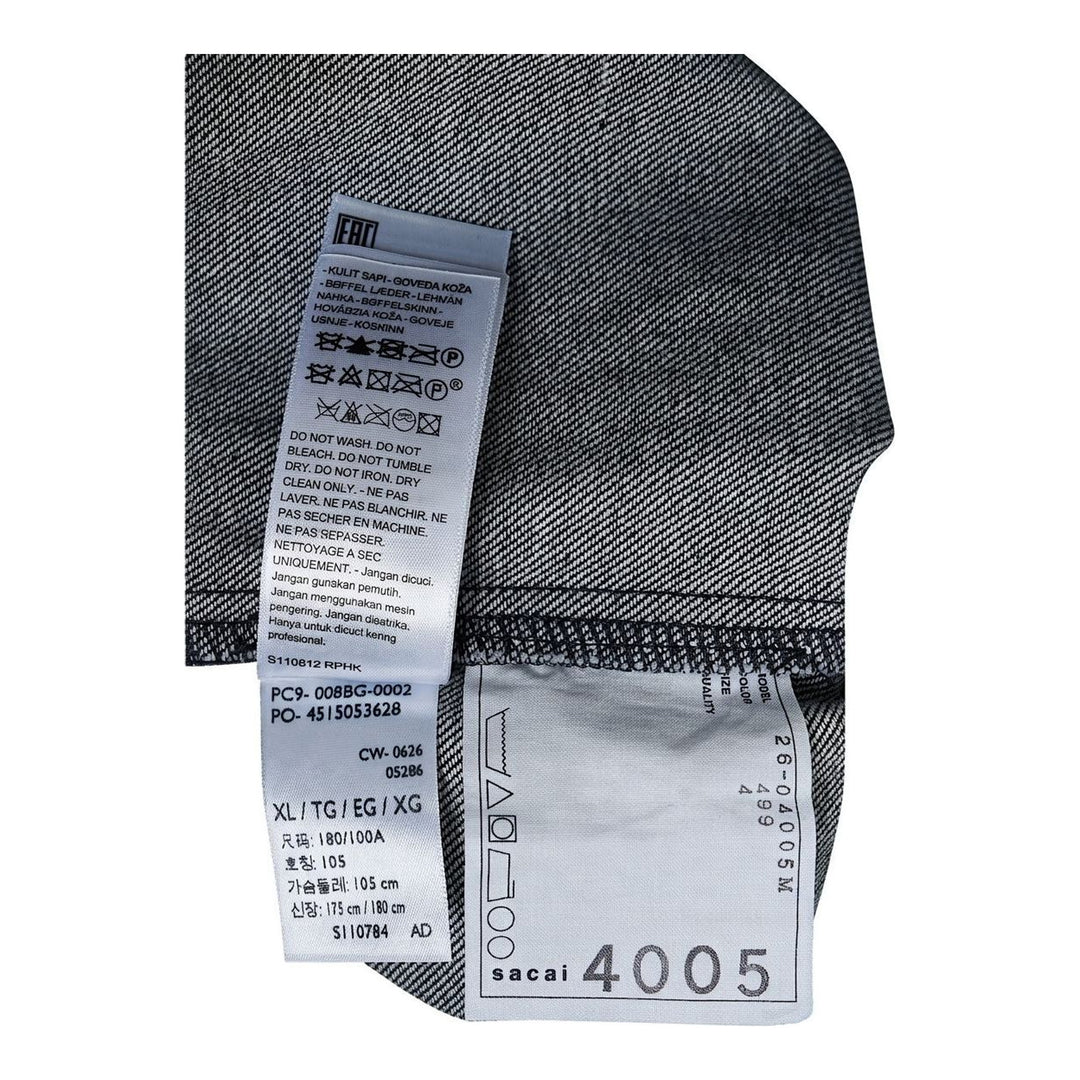 sacai Holiday Capsule mid-blue denim blouson with brown sherpa collar, cuffs and hem, an oversized leather front pocket and buckled side straps - packshot