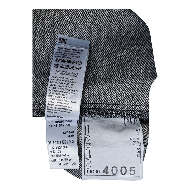sacai Holiday Capsule mid-blue denim blouson with brown sherpa collar, cuffs and hem, an oversized leather front pocket and buckled side straps - packshot