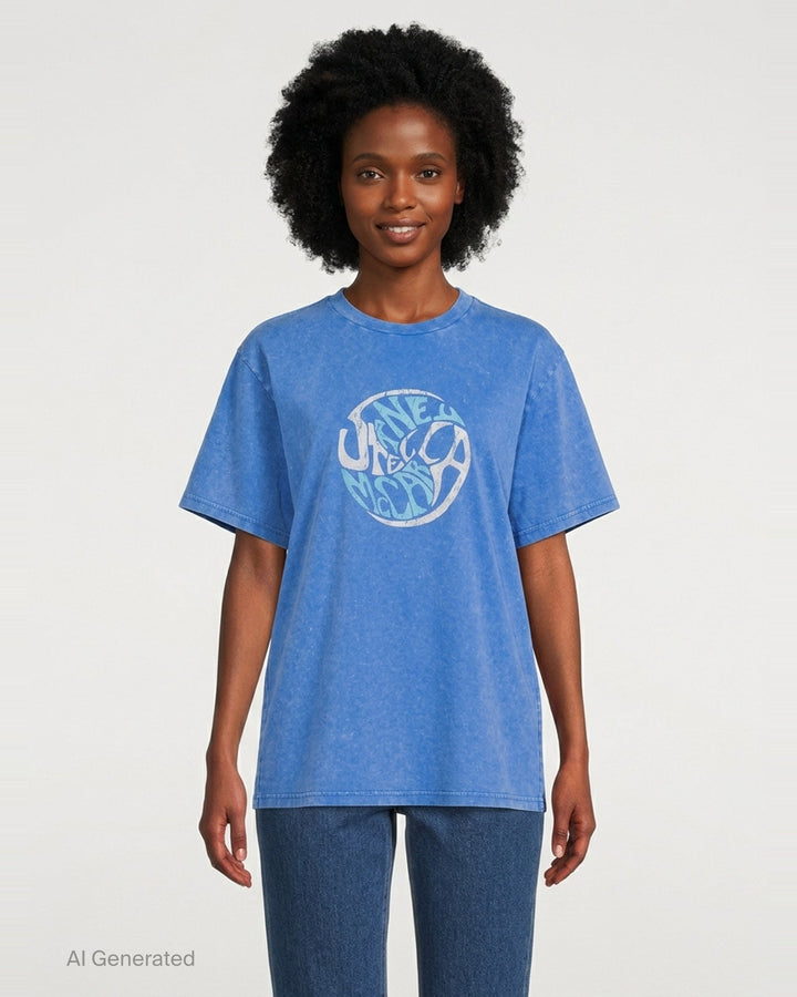 Stella McCartney Abbey Road Boyfriend Tee in acid-washed cobalt blue with a circular psychedelic logo graphic in white and aqua, crew neckline and short sleeves, front view on white background - front