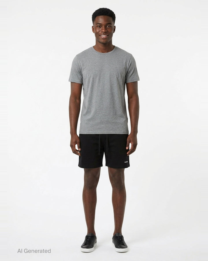 TEAM WANG design Original 1 Track Shorts in black, featuring an elasticated drawstring waistband and tonal logo print at the hip, shown flat against a white background - front