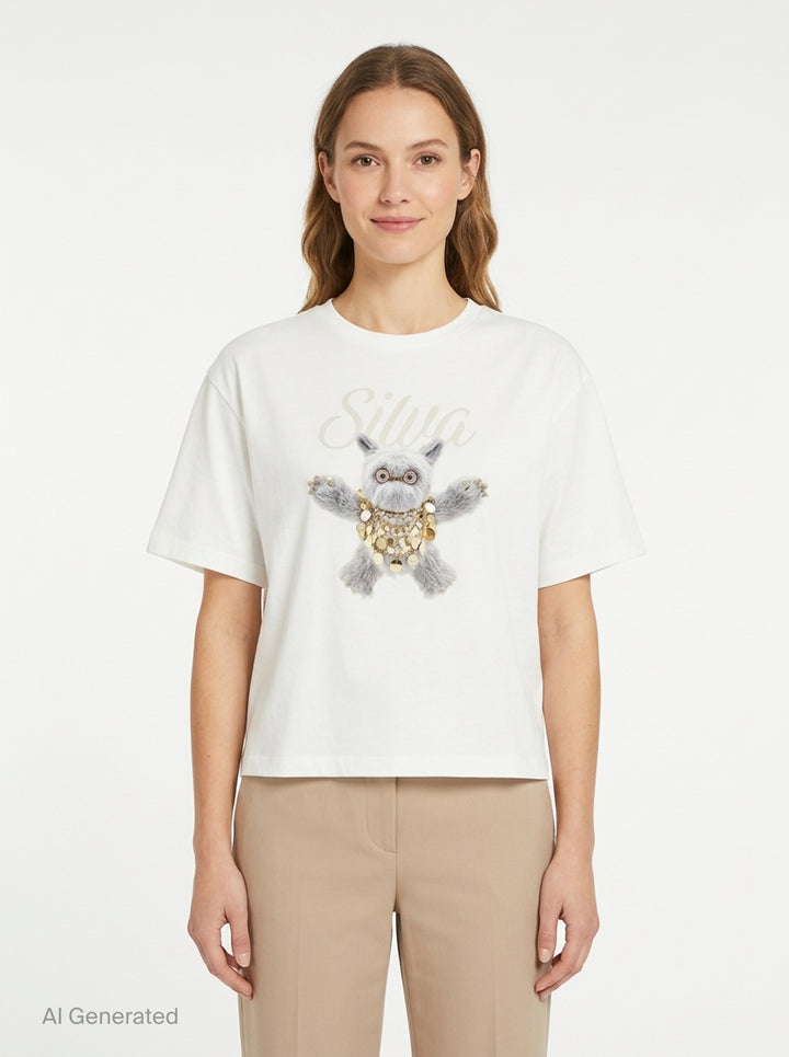 Back view of The Fluffadoos Silva Name Story Tee in white, featuring a large printed graphic of a fluffy grey creature wearing gold coin jewellery with 'Silva' script lettering above - front