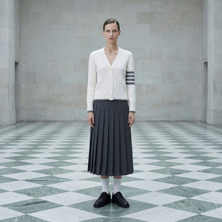 Thom Browne cream cable-knit V-neck cardigan with grey 4-bar stripes on the sleeve and contrast grey trim at the hem and cuffs - lifestyle
